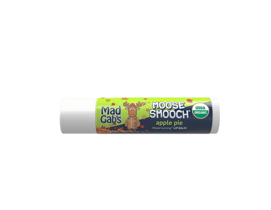 Mad Gab's Moose Smooch apple pie lip balm in a white plastic tube with a colorful label featuring a cartoon moose and green and navy sections.
