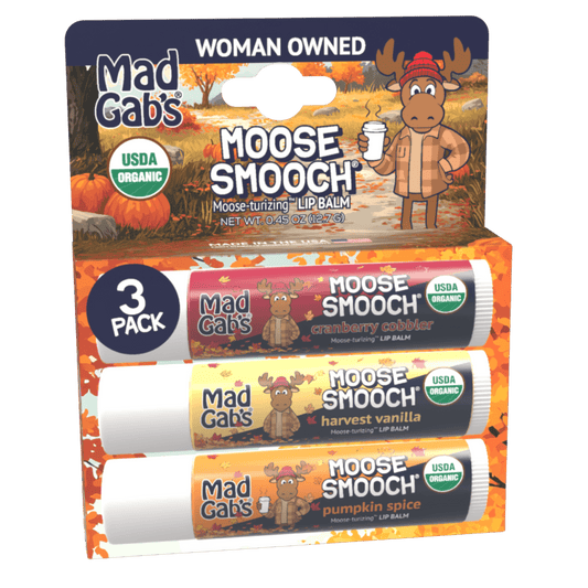 Mad Gab's Moose Smooch lip balm 3-pack in a retail display card. The packaging features an autumn-themed design with pumpkins, fall leaves, and a cartoon moose, showing three individual lip balms: cranberry cabber, harvest vanilla, and pumpkin spice.